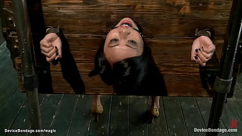 Asian ultra-cutie locked in wall and ball-gagged for your enjoyment